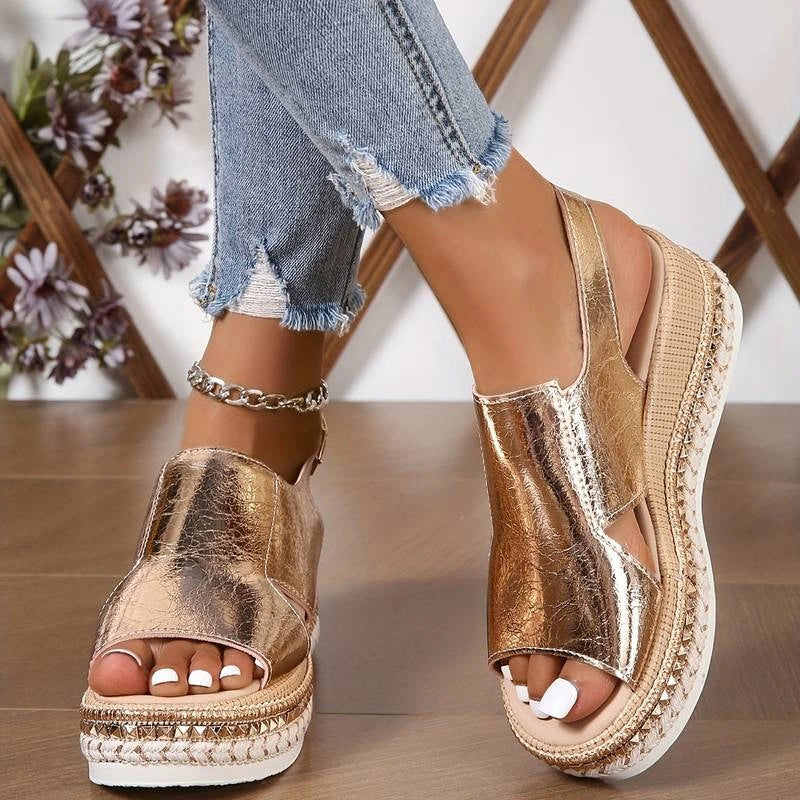 Woman wearing a gold wedge heeled platform orthopedic sandal - lifestyle photo