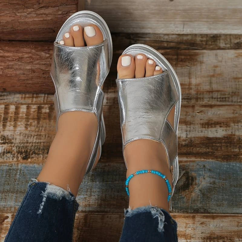 Woman wearing a silver wedge heeled platform orthopedic sandal - lifestyle photo