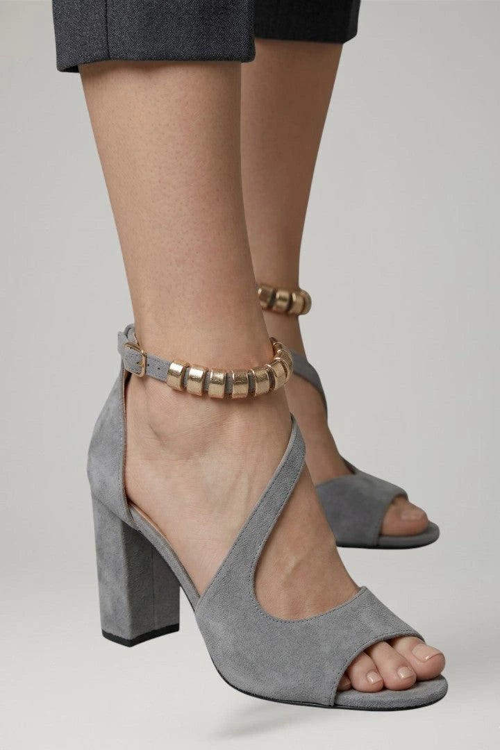 Woman wearing grey block heel adjustable strap sandals - lifestyle photo