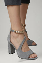 Woman wearing grey block heel adjustable strap sandals - lifestyle photo