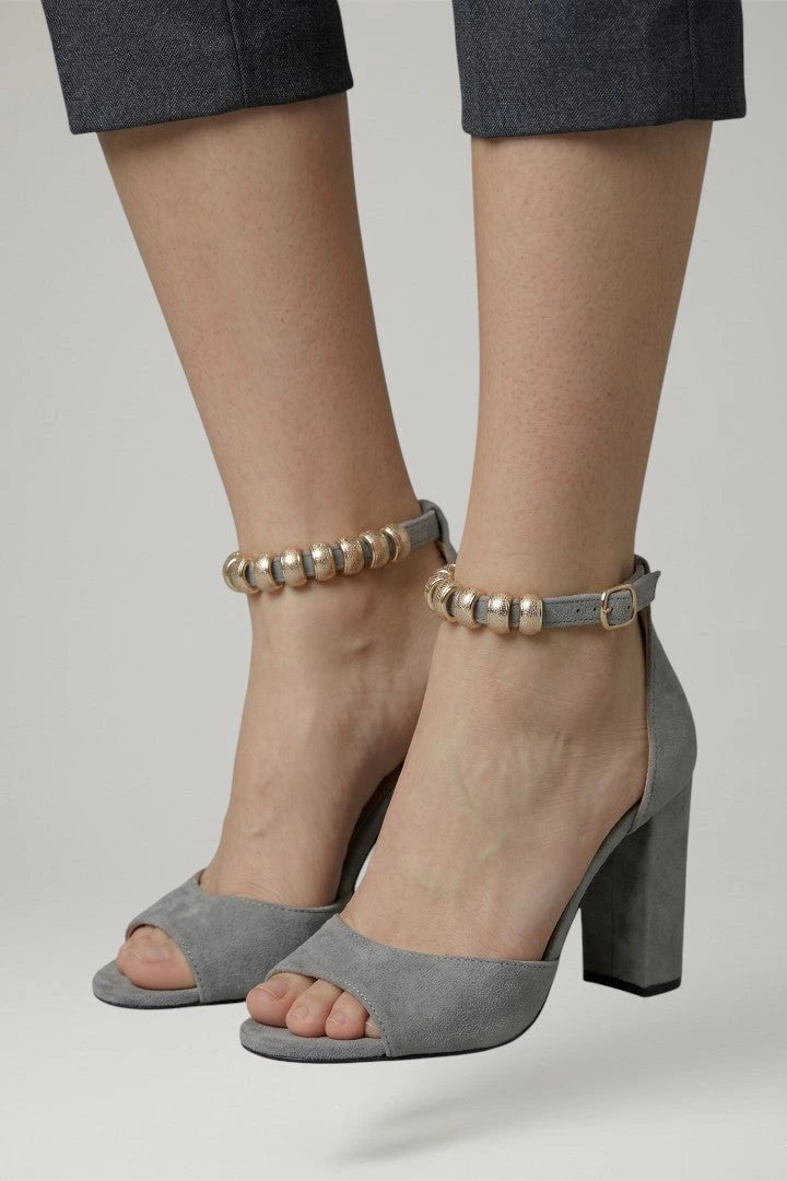 Woman wearing grey block heel adjustable strap sandals - lifestyle photo