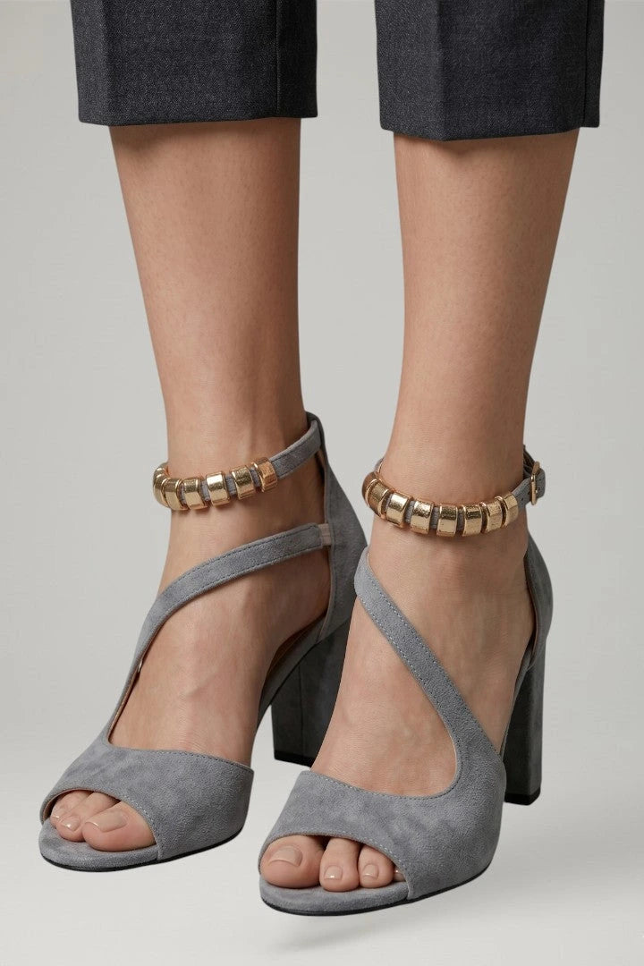 Woman wearing grey block heel adjustable strap sandals - lifestyle photo