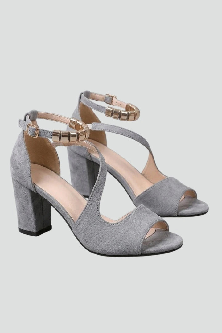 Woman wearing grey block heel adjustable strap sandals - studio photo