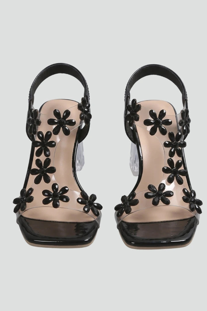 Woman wearing black block heel cushioned sandals - studio photo