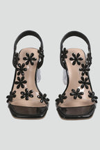 Woman wearing black block heel cushioned sandals - studio photo