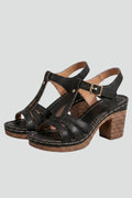 Woman wearing black block heel cushioned open-toe sandals - studio photo