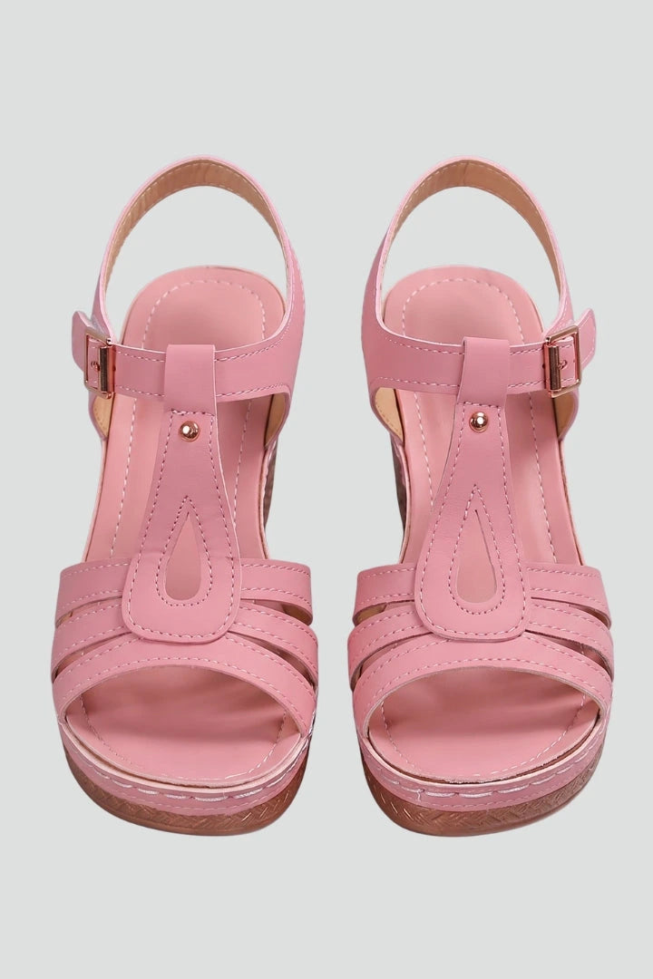 Woman wearing pink block heel cushioned strap sandals - studio photo