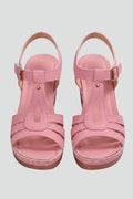 Woman wearing pink block heel cushioned strap sandals - studio photo