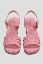 Woman wearing pink block heel cushioned strap sandals - studio photo