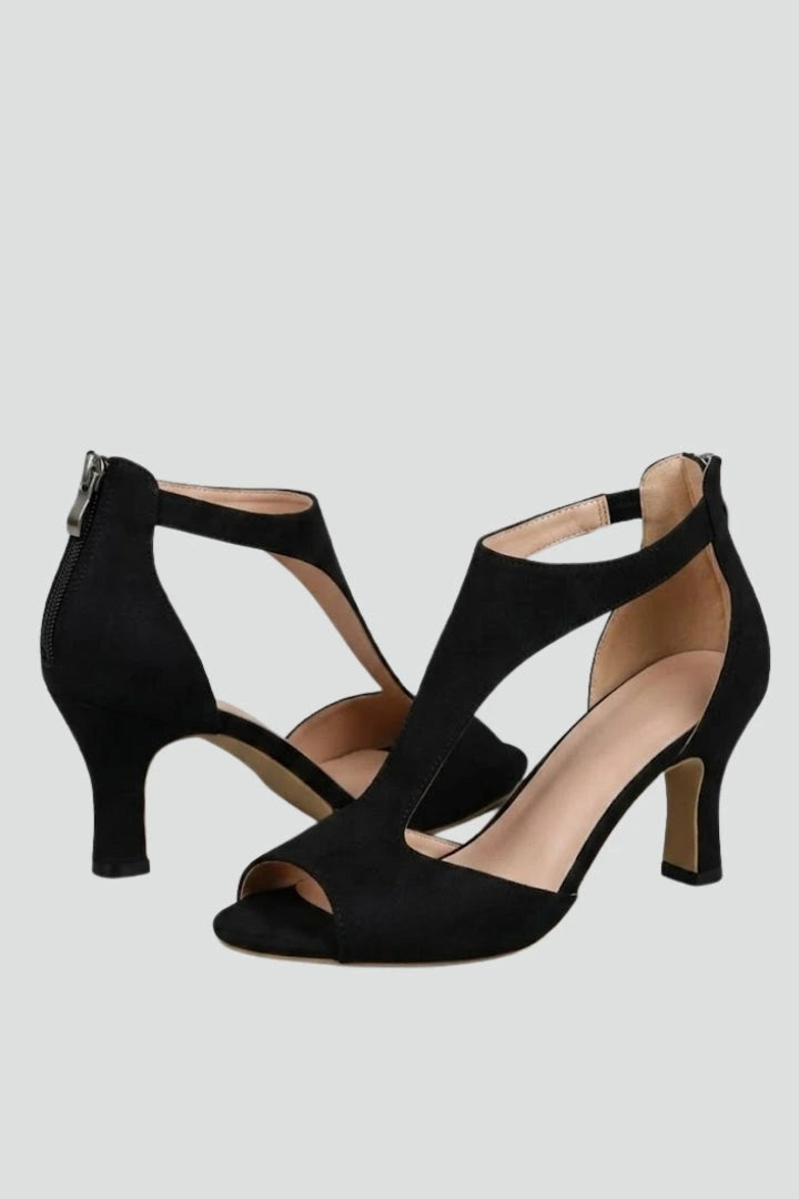 Woman wearing black block heel cutout upper sandals - studio photo