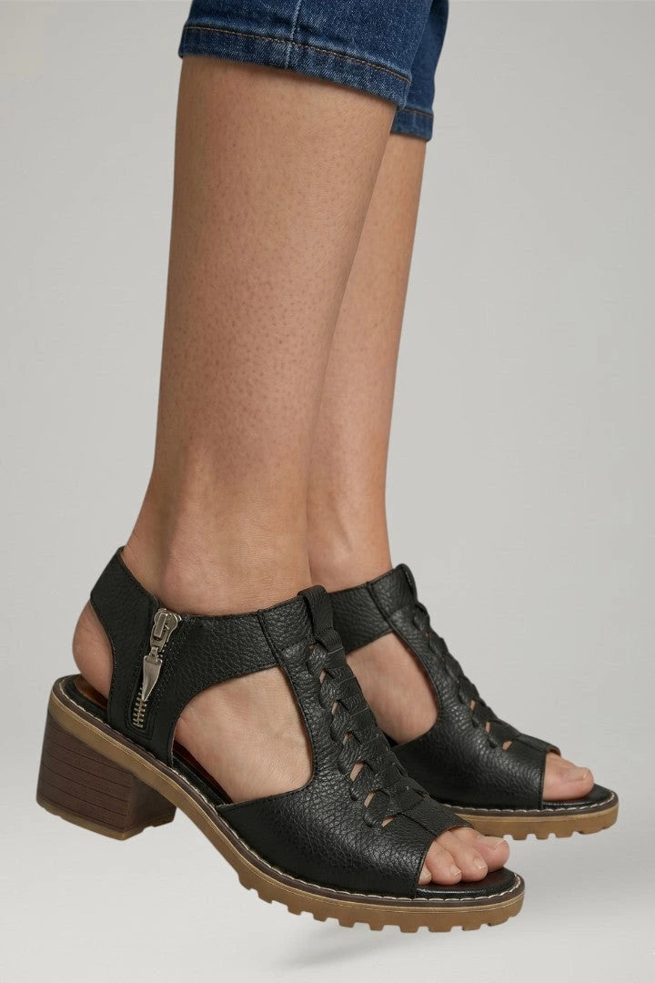 Woman wearing black block heel zip closure sandals - lifestyle photo