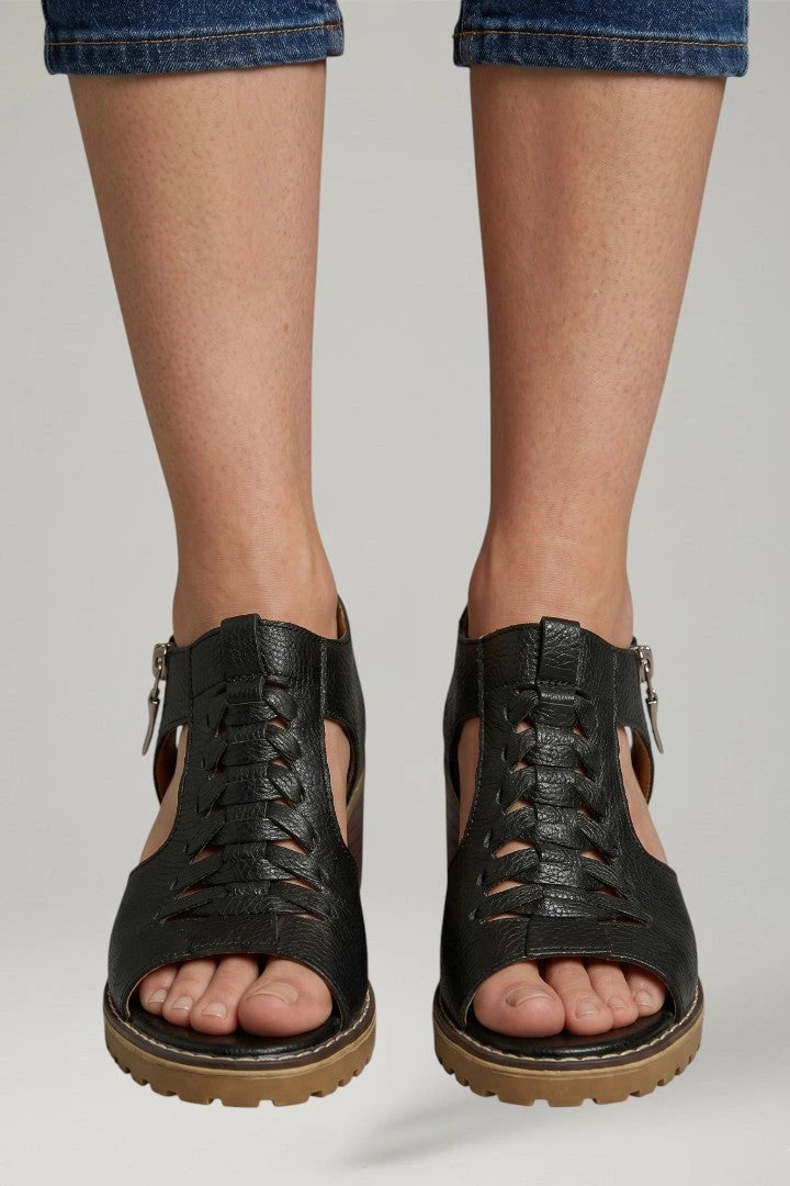 Woman wearing black block heel zip closure sandals - lifestyle photo