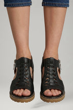 Woman wearing black block heel zip closure sandals - lifestyle photo