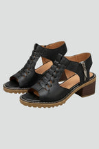 Woman wearing black block heel zip closure sandals - studio photo