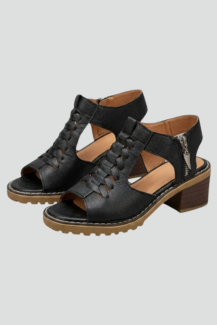 Woman wearing black block heel zip closure sandals - studio photo