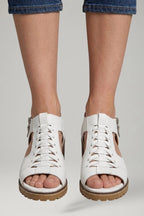 Woman wearing white block heel zip closure sandals - lifestyle photo