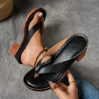 Woman wearing a black heeled thong orthopedic sandals - studio photo