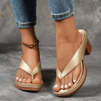 Woman wearing a gold heeled thong orthopedic sandals - lifestyle photo