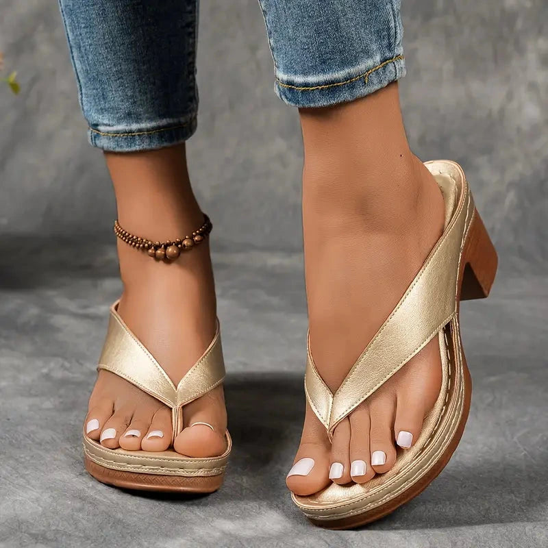 Woman wearing a gold heeled thong orthopedic sandals - lifestyle photo