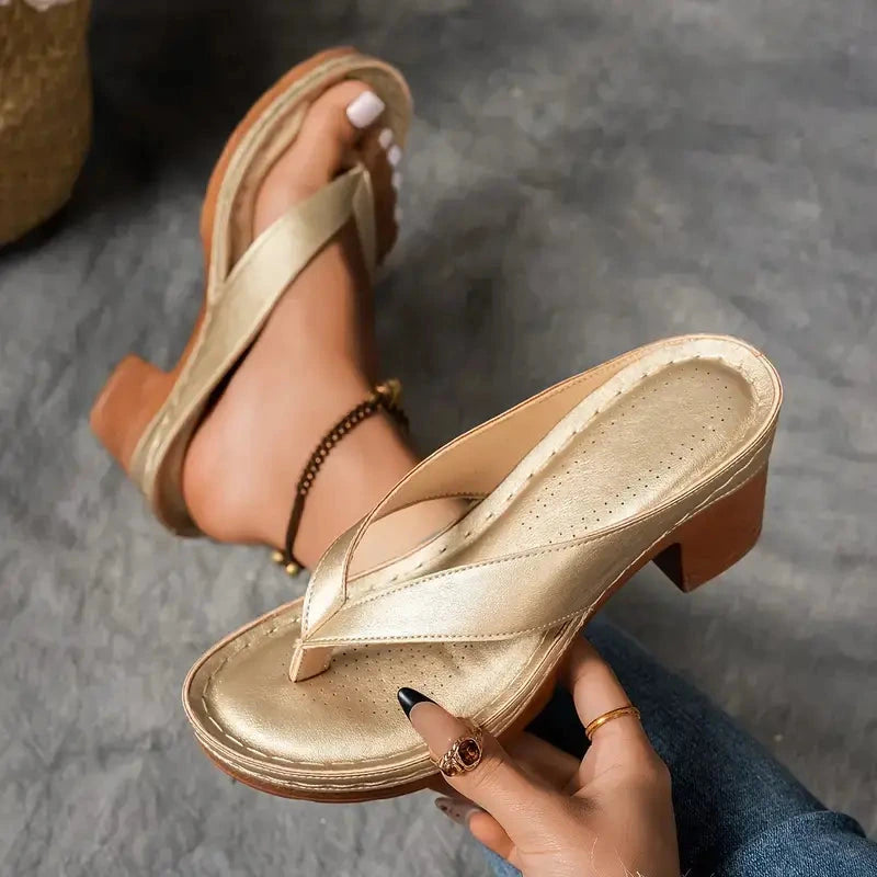 Woman wearing a gold heeled thong orthopedic sandals - lifestyle photo