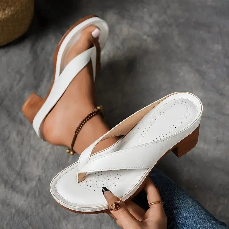 Woman wearing a white heeled thong orthopedic sandals - lifestyle photo