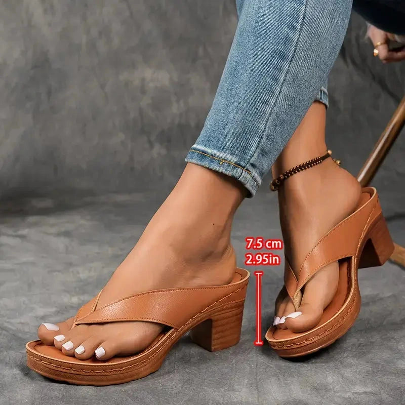 Woman wearing a white heeled thong orthopedic sandals - studio photo
