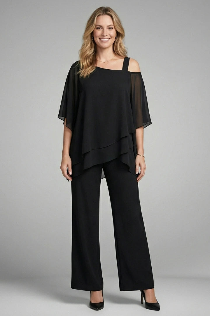 Woman wearing a black asymmetrical top wide leg set - studio photo