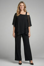 Woman wearing a black asymmetrical top wide leg set - studio photo