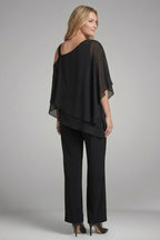 Woman wearing a black asymmetrical top wide leg set - studio photo