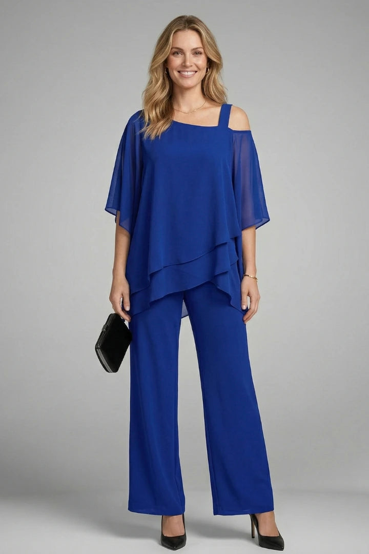 Woman wearing a blue asymmetrical top wide leg set - studio photo