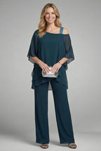 Woman wearing a navy blue asymmetrical top wide leg set - studio photo