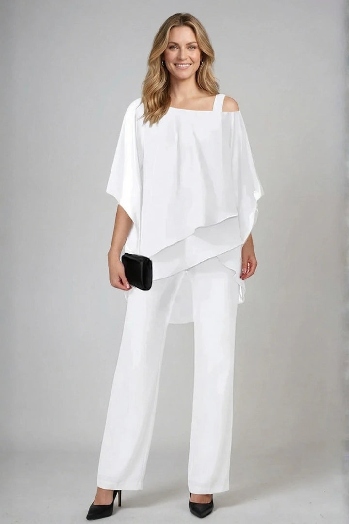 Woman wearing a white asymmetrical top wide leg set - studio photo