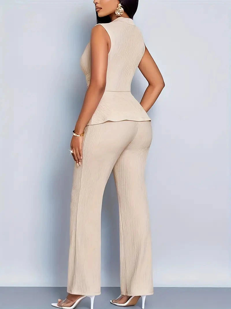 Woman wearing a beige sleeveless top trousers set - studio photo