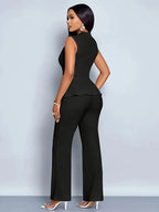 Woman wearing a black sleeveless top trousers set - studio photo