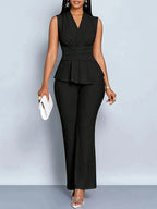 Woman wearing a black sleeveless top trousers set - studio photo