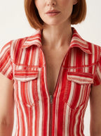 Close-up of red and white striped shirt showing collar, zipper front, and chest pockets.