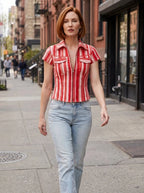 Red and white striped denim-look shirt worn outdoors on a city street.