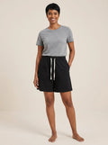 Black cotton wide-leg shorts with elastic waistband and white drawstring, studio front view.
