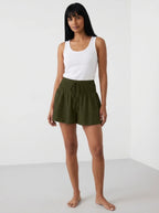 Dark green high-waist drawstring shorts with shirred waistband, relaxed fit, studio front view.