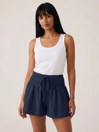 Navy high-waist drawstring shorts with shirred waistband, relaxed fit, studio front view.