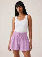 Light purple high-waist drawstring shorts with shirred waistband, relaxed fit, studio front view.