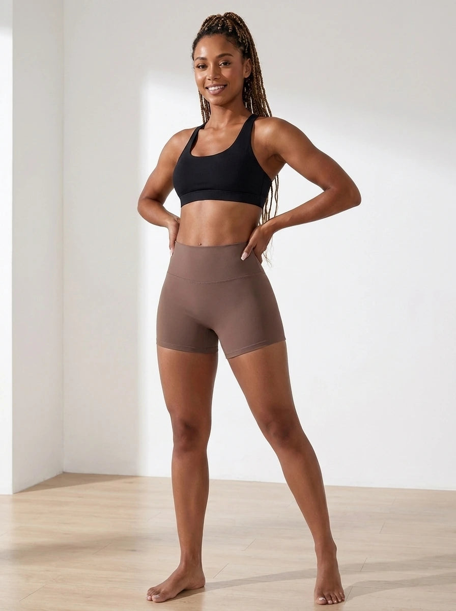 Brown high-waisted yoga shorts, slim fit, soft stretchy fabric, studio front view.