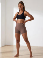 Brown high-waisted yoga shorts, slim fit, soft stretchy fabric, studio front view.