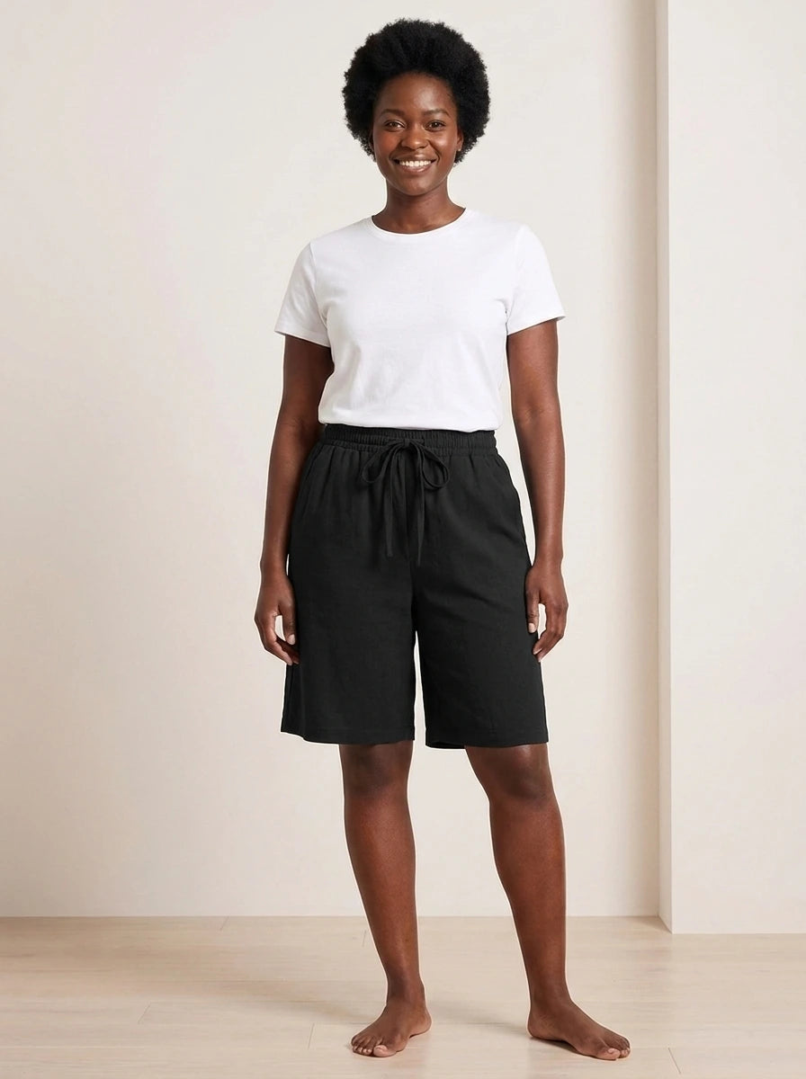 Black lightweight casual summer shorts with elastic waistband and relaxed fit, studio front view.