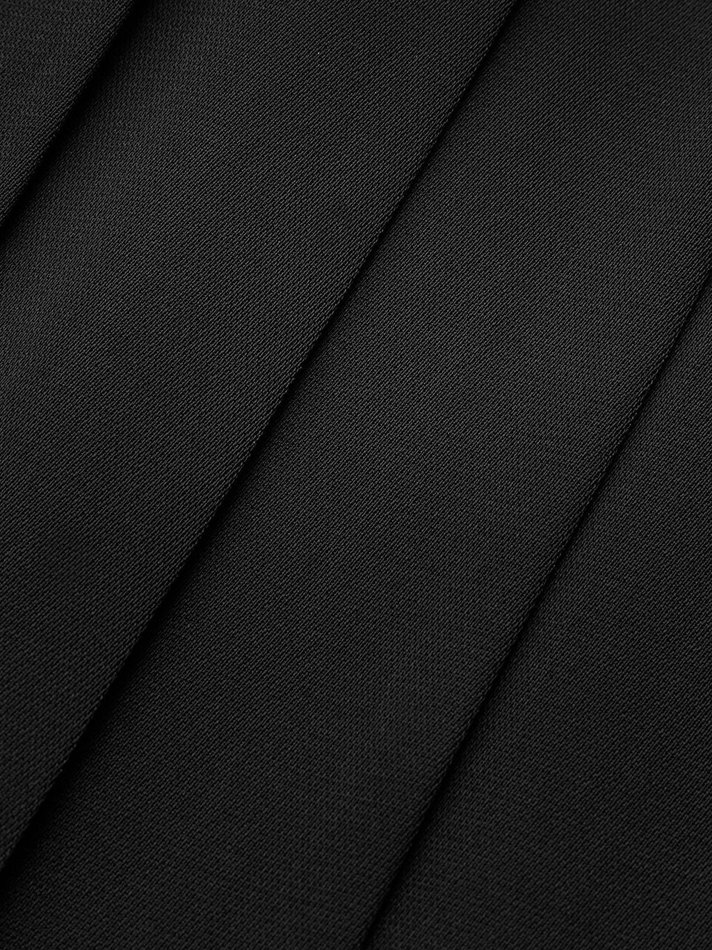 Woman wearing a dark brown pleated maxi skirt - studio photo