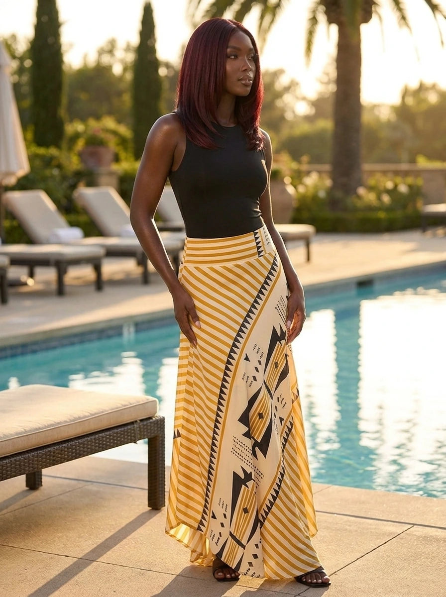 Woman wearing a yellow geometric print satin maxi skirt at a resort poolside
