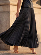Woman wearing a black structured bodice pleated skirt set - editorial style photo