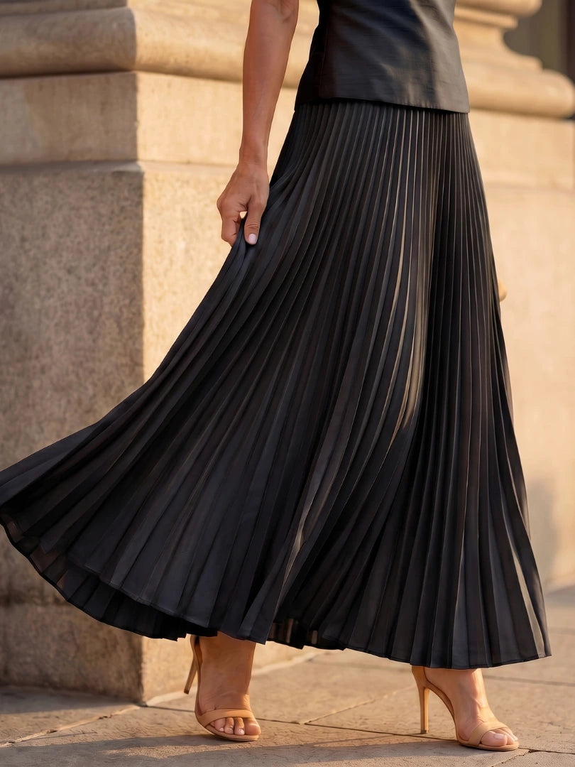 Woman wearing a black structured bodice pleated skirt set - editorial style photo