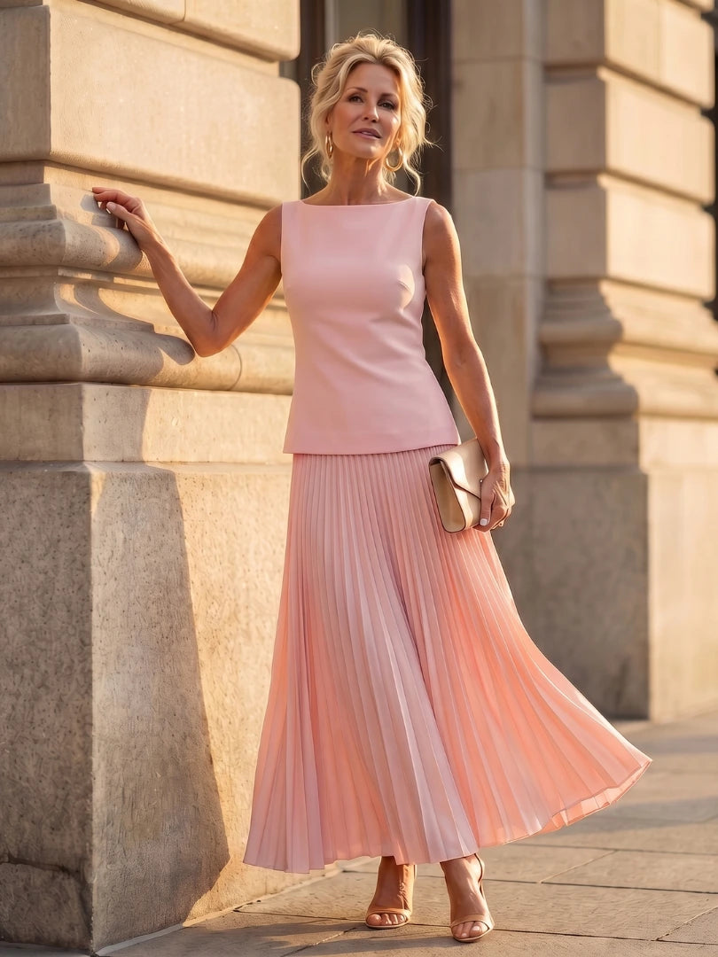 Woman wearing a pink structured bodice pleated skirt set - editorial style photo