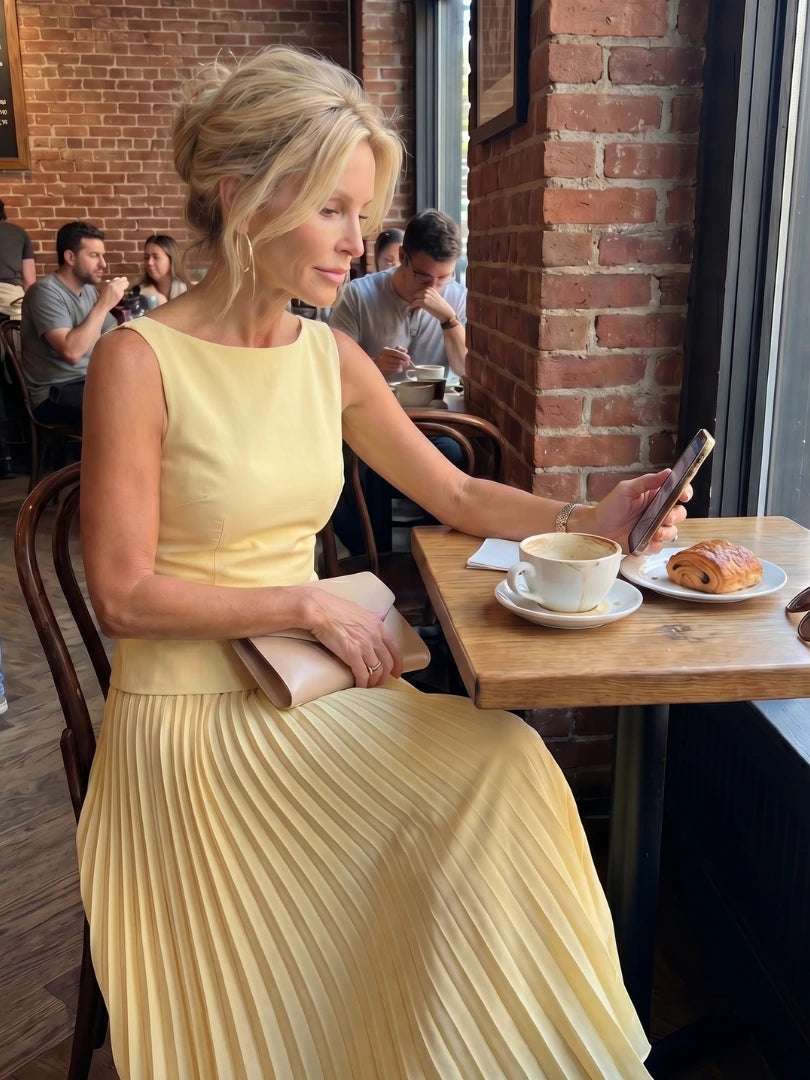 Woman wearing a yellow structured bodice pleated skirt set - editorial style photo
